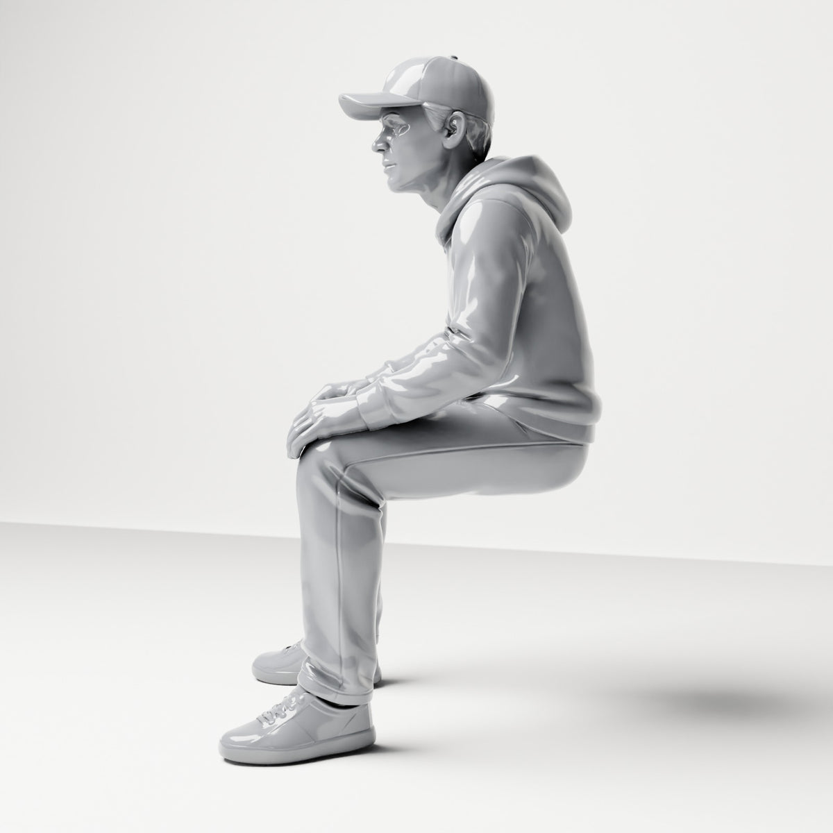 Diorama Modellbau Produktfoto 1: Sitzende Figur: Mann mit Kappe & Kapuzenpullover (B070)