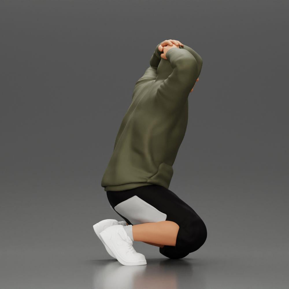 Diorama Modellbau Produktfoto 1: Kniender Mann mit Kapuzenpullover, Hände hinter dem Kopf - Diorama Miniatur (Ref Nr. A70)