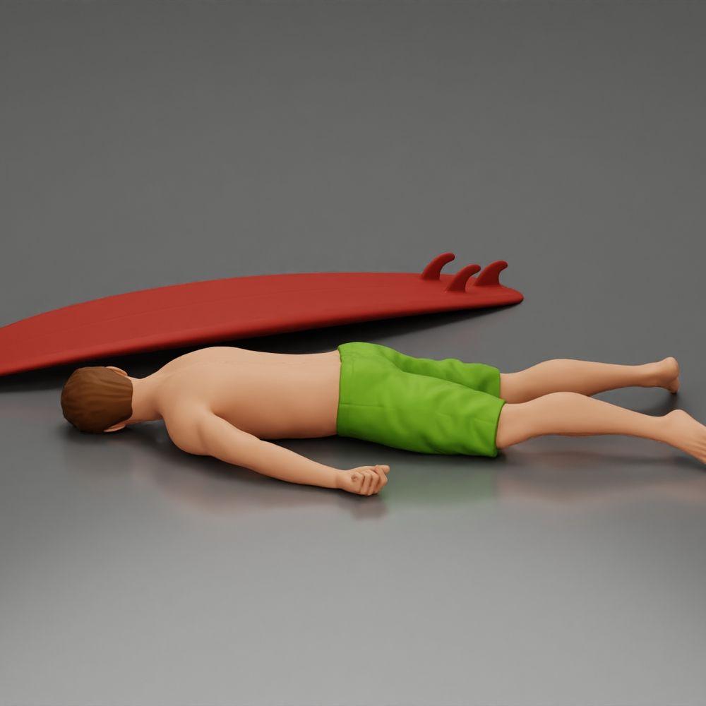Diorama Modellbau Produktfoto 3: Diorama-Miniatur: Liegende Person bäuchlings neben Surfbrett mit Finnen (Ref Nr. A66)